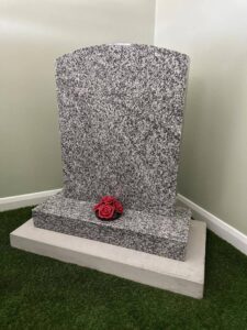 cluster red roses on grave