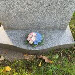 forget me not and primrose on grave